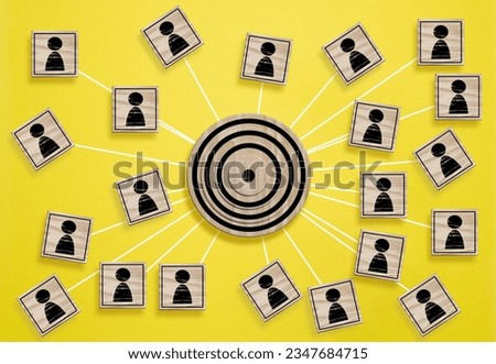 A wooden round target and wooden cubes with figure icon are connected, symbolizing the concept of target audience identification Royalty-Free Stock Photo #2347684715