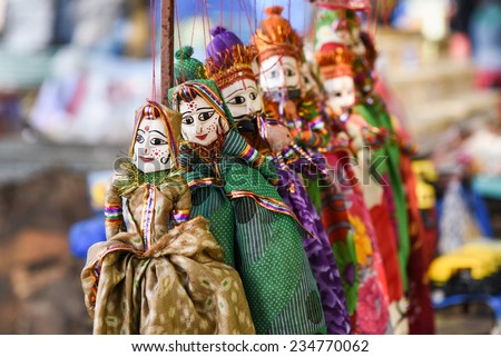 hand made puppets attached to string in Rajasthan India dolls. Women face with traditional Indian makeup wearing saree / sari Royalty-Free Stock Photo #234770062