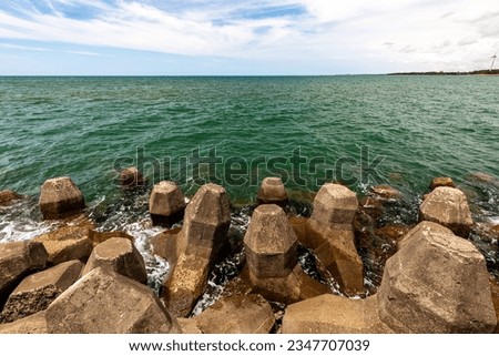 Coastal landscape of Taiwan, where green seawater meets with breakwaters. Royalty-Free Stock Photo #2347707039