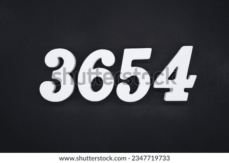 Black for the background. The number 3654 is made of white painted wood.