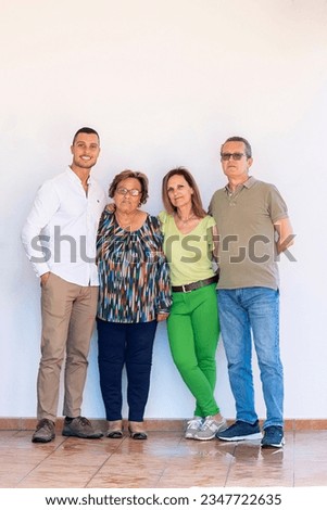 Close view of a happy family together over a white wall background.