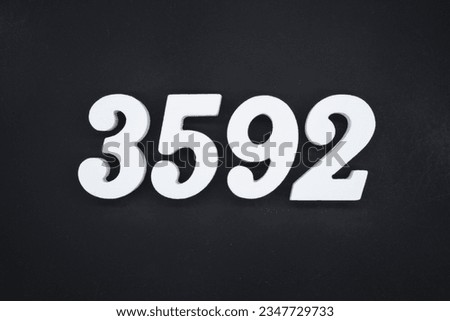 Black for the background. The number 3592 is made of white painted wood.