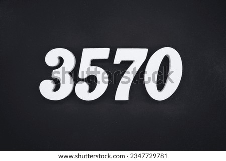 Black for the background. The number 3570 is made of white painted wood.