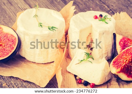 vintage photo of goats cheeses on wooden background