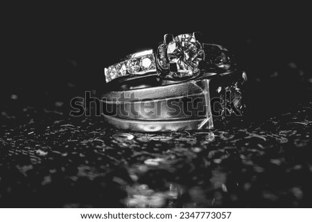 Wedding rings on glitter red background. Modern wedding ring. Beautiful wedding or engagement ring symbol.White and back
