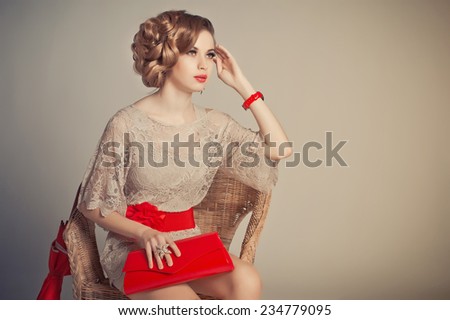 Advertising of ornaments and accessories, the photo of the girl on a grey background to the utmost.