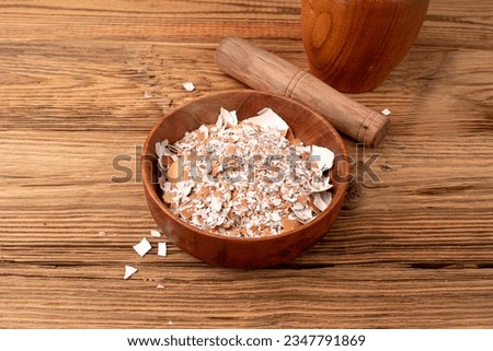 Broken Egg Shell in Bowl, Crushed Eggshell, Calcium Supplement, Cracked Eggshells, Natural Compost Ingredient, Broken Egg Shells on Wood Background Top View Royalty-Free Stock Photo #2347791869