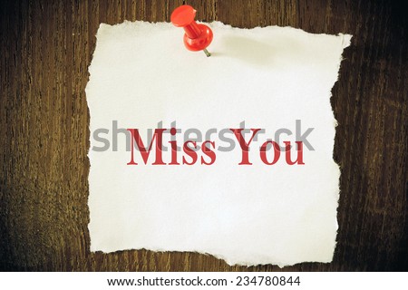 text miss you on the old envelope and clothes peg wood background 