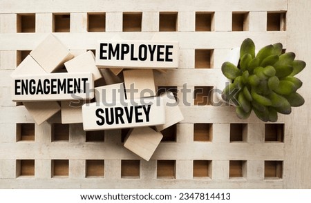 Wooden blocks with text Employee Engagement Survey on vintage background Royalty-Free Stock Photo #2347814413