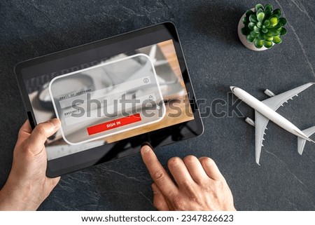 Man hands hold and touch tablet PC with login box, travel concept.