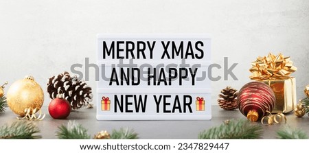 Lightbox with text Merry xmas and happy new year and christmas decor on the table against white background. Front view banner