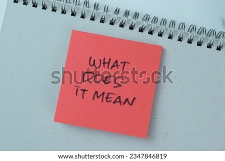 Concept of What Does It Mean write on sticky notes isolated on Wooden Table.