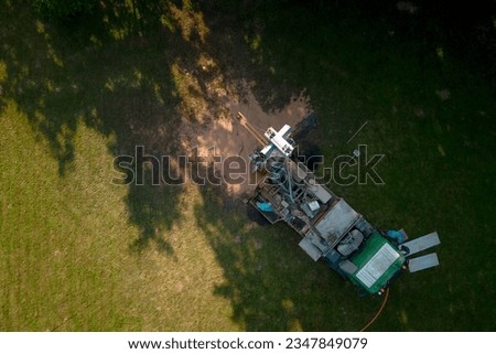 Aerial shot of water well drilling rig boring dowin into the earth.