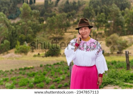 Indigenous woman talking on the phone in the field Royalty-Free Stock Photo #2347857113