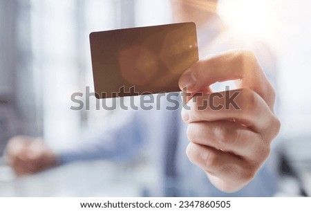 A man holds a black business card. A paper in the hands of a man. Prepared for your text.