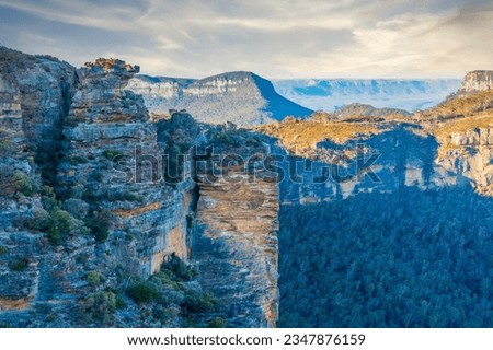 Photograph of the rugged and rocky cliff face of mountains the Megalong Valley in the Blue Mountains in New South Wales in Australia