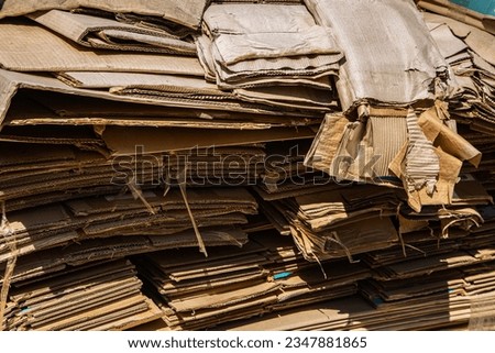 Stack of corrugated paper waste before sending to shred and recycle at recycling plant. Old, randomly folded paper. Corrugated fiberboard.  Royalty-Free Stock Photo #2347881865
