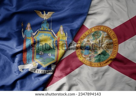 big waving colorful national flag of florida state and flag of new york state . macro