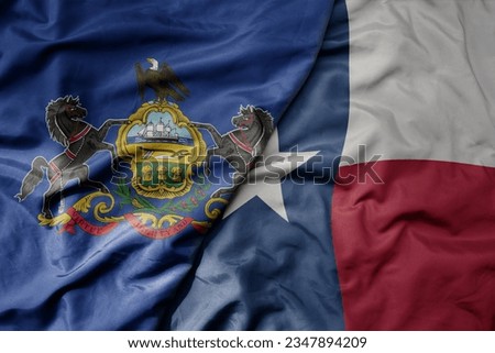 big waving colorful national flag of texas state and flag of pennsylvania state . macro