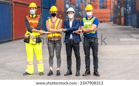 Professional engineer container cargo foreman team in helmets working standing and using walkie talkie checking stock into container for loading.logistic transport and business industry export