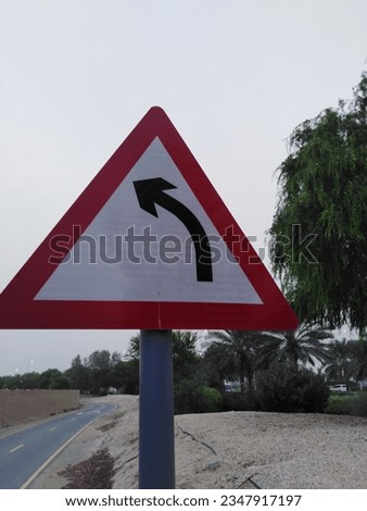 Left Arrow traffic Board on road, Triangle shape Red and white traffic sign board with Black color Left side Arrow