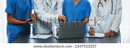Doctor and nurse in medical meeting discussing strategic medical treatment plan together with report and laptop. Medical school workshop training concept in panoramic banner. Neoteric Royalty-Free Stock Photo #2347923257