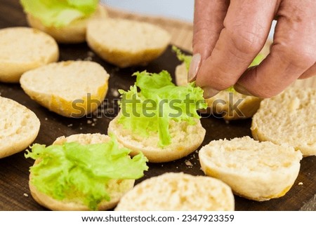 Step by step preparation of mini burgers. Homemade mini burgers for children or appetizers. Small hamburgers. Assembling burgers