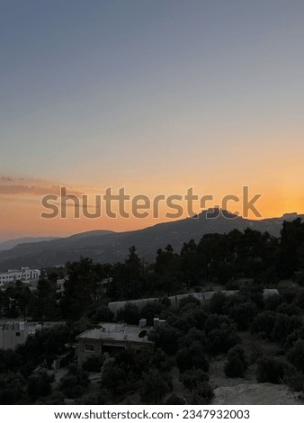 Sunset embrace over Ajloun: Castle silhouette against a warm-hued sky. Timeless beauty painted in the evening's glow.