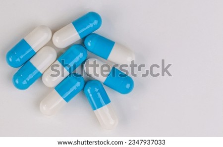 Colorful pill capsule on white background.