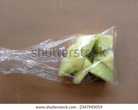 The melons are cut into small pieces and then put in plastic