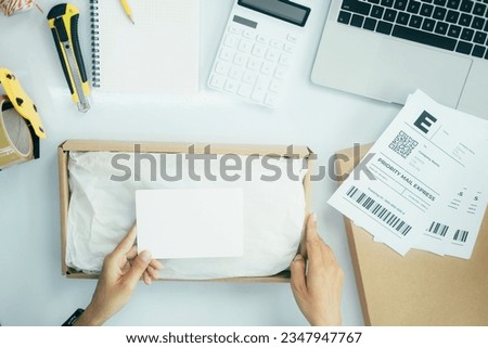 Closeup view of female online store small business owner seller entrepreneur packing package post shipping box preparing delivery parcel on table. Ecommerce dropshipping shipment service concept.