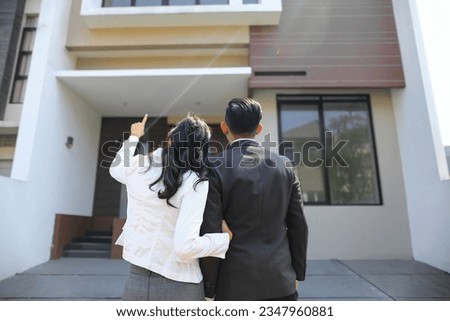 the couple was choosing a house for their stay, she pointed at one of the houses. Royalty-Free Stock Photo #2347960881