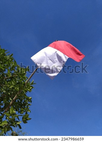 Indonesian red and white flag with blue sky