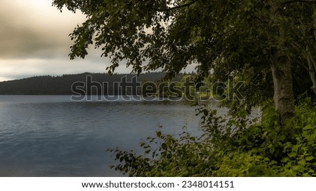 Early morning image with cloudy weather and calm water