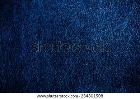 Dark blue glossy leather texture abstract, iridescent material navy toned, rough surface background in horizontal orientation, nobody.