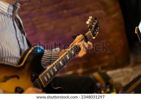 Guitarist hands play an electric guitar. High quality photo