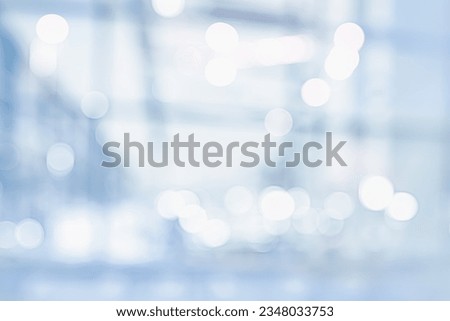 BLURRED CITY BUSINESS OFFICE HALL BACKGROUND, MODERN COMMERCIAL INTERIOR WITH LARGE WINDOWS AND GLASS BOKEH LIGHTS Royalty-Free Stock Photo #2348033753