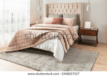 interior of luxury bedroom with beige and white Home Velvet and Cotton Tufted Quilt, blanket pillows on bed Royalty-Free Stock Photo #2348037527