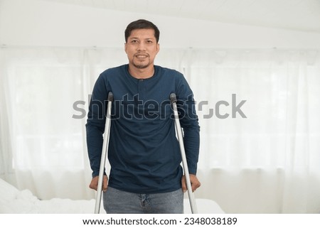 Asian patient man using crutches. Patient male with crutches in hospital  Royalty-Free Stock Photo #2348038189