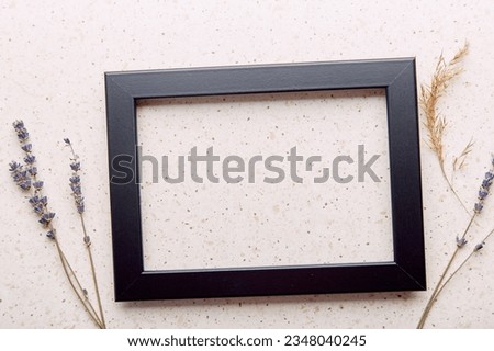 Empty interior black wall frame mockup, minimalist fine art template with lavender and cane.