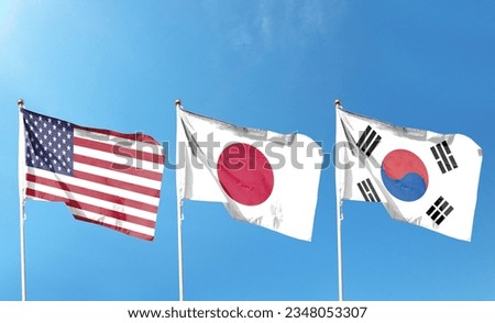 American flag with Japan flag and South Korea flag on cloudy sky. waving in the sky Royalty-Free Stock Photo #2348053307