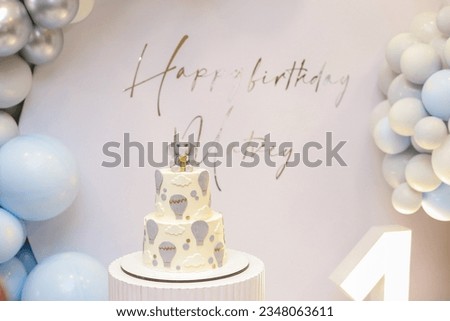 birthday cake. sweets. Baby cake. two tiered cake. image of an elephant and a balloon on a cake. Happy birthday. Birthday party. Decoration