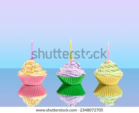 Three colorful party cupcakes with decoration and candles on beauty table. Image of cheerful holiday.