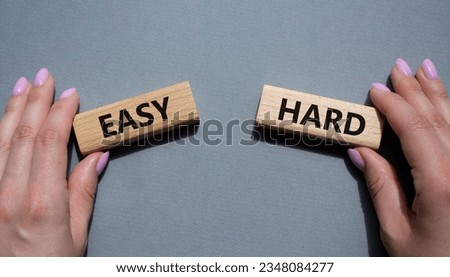 Easy or Hard symbol. Concept word Easy or Hard on wooden blocks. Businessman hand. Beautiful grey background. Business and Easy or Hard concept. Copy space Royalty-Free Stock Photo #2348084277