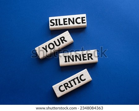 Silence your inner critic symbol. Wooden blocks with words Silence your inner critic. Beautiful deep blue background. Business and Silence your inner critic concept. Copy space.