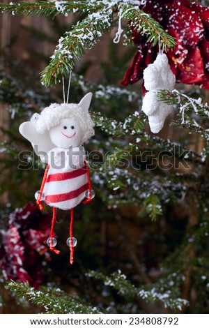 christmas decoration handmade toy Angel hanging over rustic wooden background