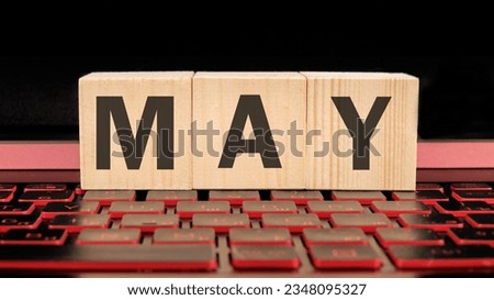 May written on wooden cubes on the laptop keyboard