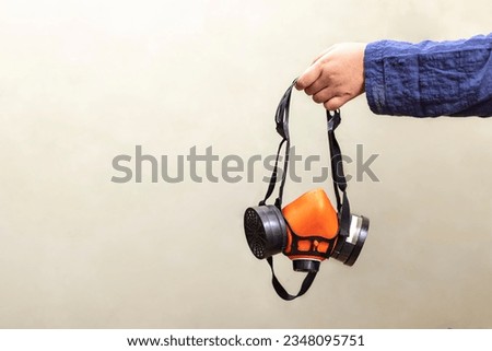 a device designed to protect the wearer from inhaling hazardous atmospheres including fumes, vapours, gases and particulate matter such as dusts and airborne pathogens such as viruses Royalty-Free Stock Photo #2348095751