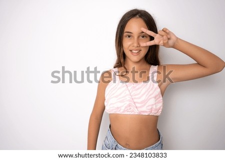 Little caucasian girl over isolated background showing victory sign with both hands