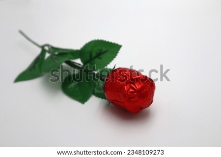 Sweet chocolate red rose wrapped up simple romantic thank you date gift present for young love on white background